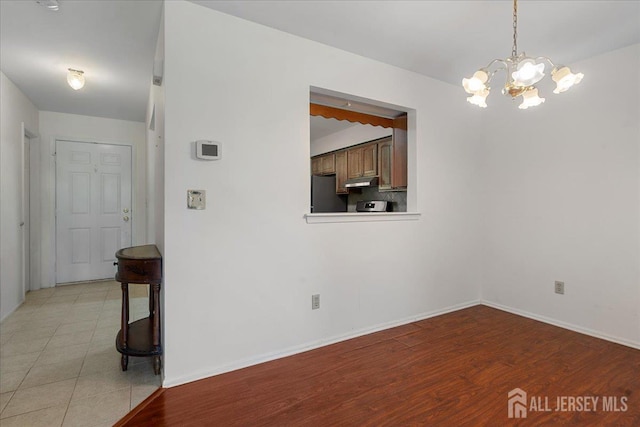 450 Saint Giles Ct, Franklin Twsp, NJ 08873 - spare room featuring a chandelier, baseboards, and light wood-type flooring