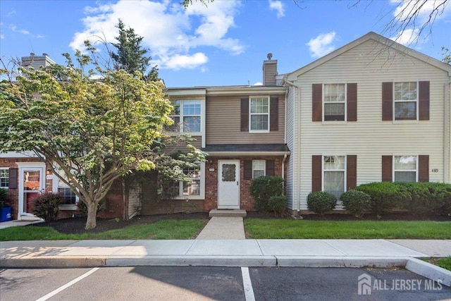 450 Saint Giles Ct, Franklin Twsp, NJ 08873 - townhome / multi-family property with a chimney and uncovered parking