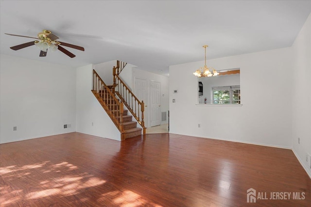 450 Saint Giles Ct, Franklin Twsp, NJ 08873 - unfurnished living room featuring stairs, wood finished floors, a chandelier, a ceiling fan, and baseboards