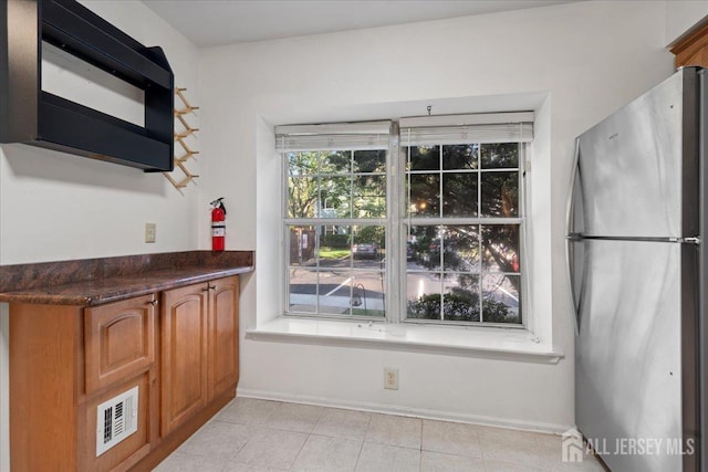 450 Saint Giles Ct, Franklin Twsp, NJ 08873 - kitchen with freestanding refrigerator, black microwave, brown cabinets, and dark countertops