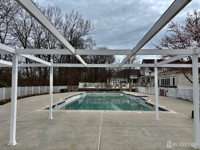 view of swimming pool with a patio, a fenced in pool, and fence