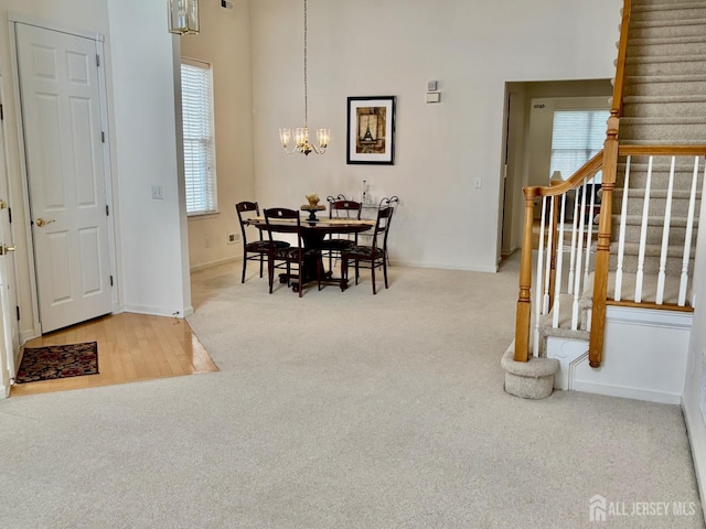 165 Einstein Way E, Windsor, NJ 08512 - carpeted dining area with baseboards, a wealth of natural light, stairway, and an inviting chandelier