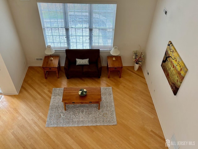 living area featuring wood finished floors and baseboards