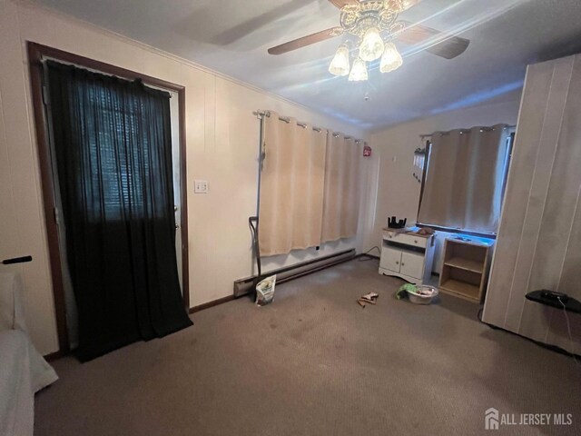 carpeted bedroom with baseboard heating and ceiling fan