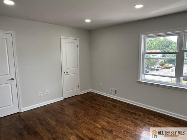 3205 Hana Rd, Edison, NJ 08817 - unfurnished bedroom with multiple windows, dark wood-style floors, and recessed lighting