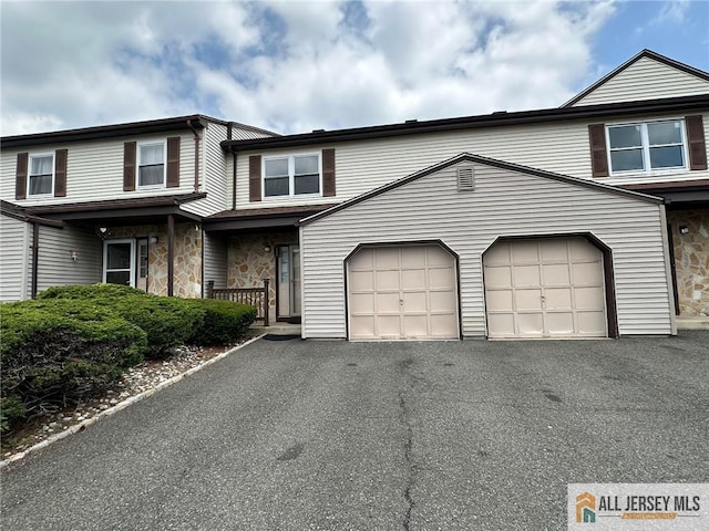 3205 Hana Rd, Edison, NJ 08817 - traditional home with asphalt driveway, stone siding, and a garage