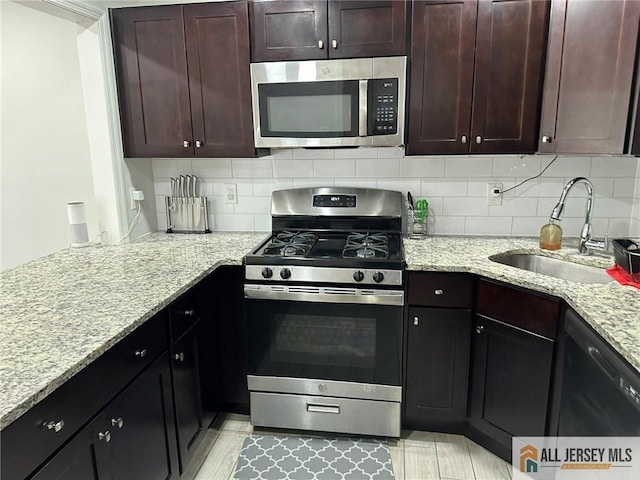 3205 Hana Rd, Edison, NJ 08817 - kitchen with stainless steel appliances, decorative backsplash, light stone counters, and dark brown cabinets