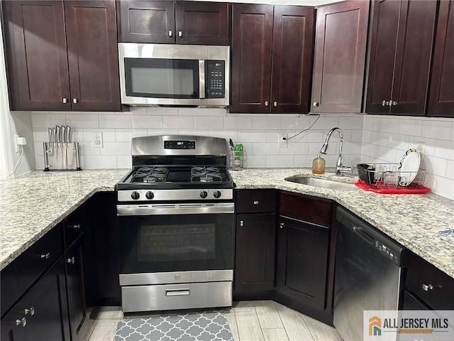 3205 Hana Rd, Edison, NJ 08817 - kitchen featuring appliances with stainless steel finishes, backsplash, light stone counters, and dark brown cabinets