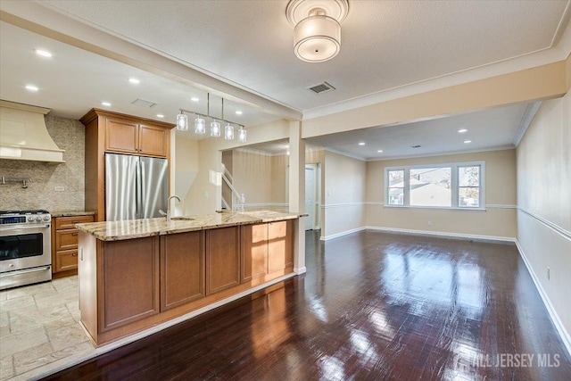 kitchen with sink, appliances with stainless steel finishes, tasteful backsplash, ornamental molding, and custom exhaust hood