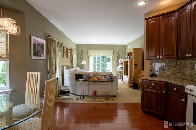 263 Valencia Dr, Monroe, NJ 08831 - kitchen with a chandelier, open floor plan, range, light stone countertops, and light carpet