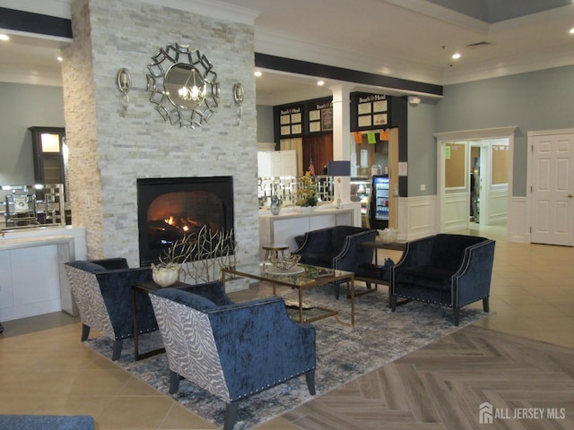 263 Valencia Dr, Monroe, NJ 08831 - living area with crown molding, a stone fireplace, wainscoting, and recessed lighting