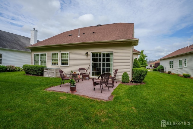 263 Valencia Dr, Monroe, NJ 08831 - back of house featuring a patio and a yard