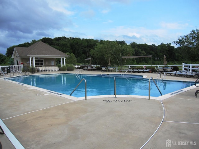 263 Valencia Dr, Monroe, NJ 08831 - community pool featuring a patio area and a wooded view