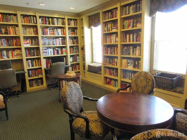 263 Valencia Dr, Monroe, NJ 08831 - sitting room with wall of books, healthy amount of natural light, and carpet floors