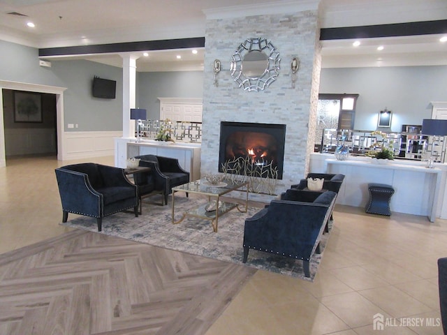 263 Valencia Dr, Monroe, NJ 08831 - living area featuring a stone fireplace, ornamental molding, a wainscoted wall, ornate columns, and recessed lighting