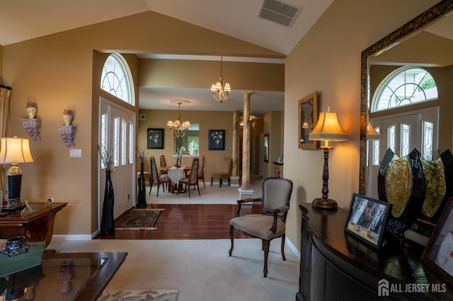 263 Valencia Dr, Monroe, NJ 08831 - entrance foyer with a chandelier, vaulted ceiling, carpet flooring, and ornate columns