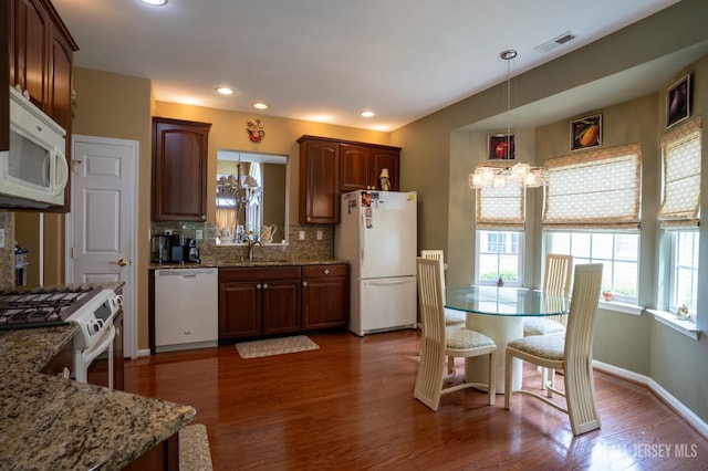263 Valencia Dr, Monroe, NJ 08831 - kitchen with white appliances, a chandelier, backsplash, dark wood-style floors, and hanging light fixtures