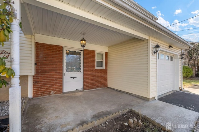 view of exterior entry featuring brick siding