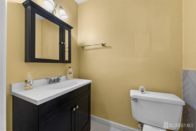 half bathroom with vanity and toilet