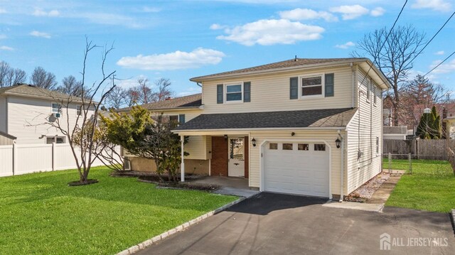 view of front of house featuring asphalt driveway, an attached garage, and roof with shingles