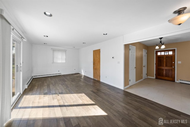 unfurnished living room featuring plenty of natural light, recessed lighting, wood finished floors, and baseboards