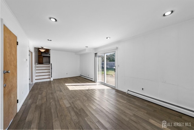 empty room with a baseboard heating unit, stairs, wood finished floors, and recessed lighting