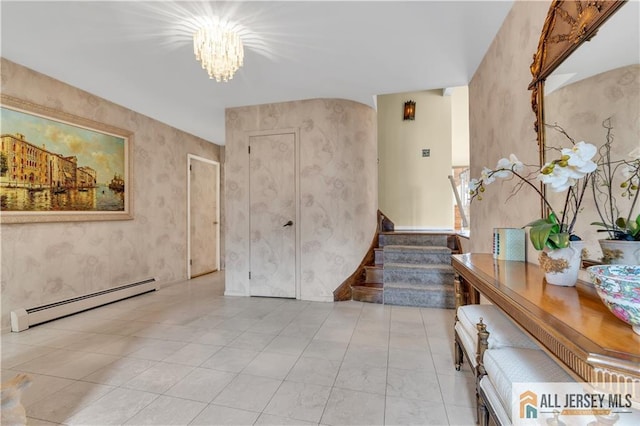 foyer entrance with a baseboard heating unit, a notable chandelier, stairway, and wallpapered walls