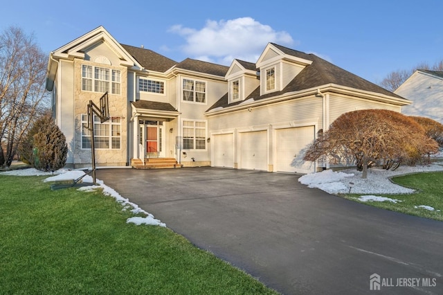 view of front of home with a garage and a front yard