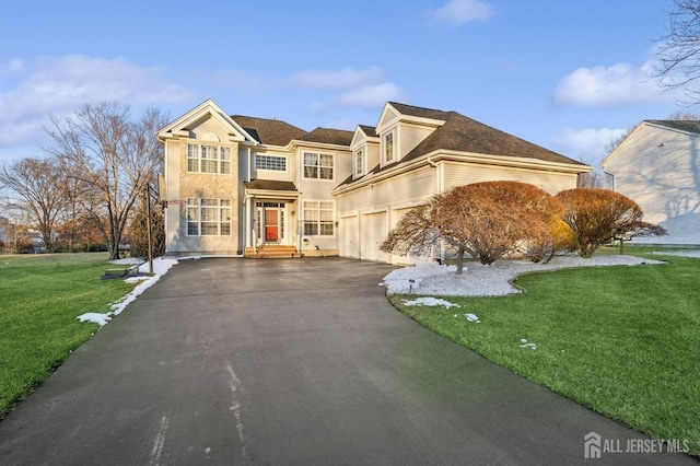 front facade featuring a garage and a front lawn