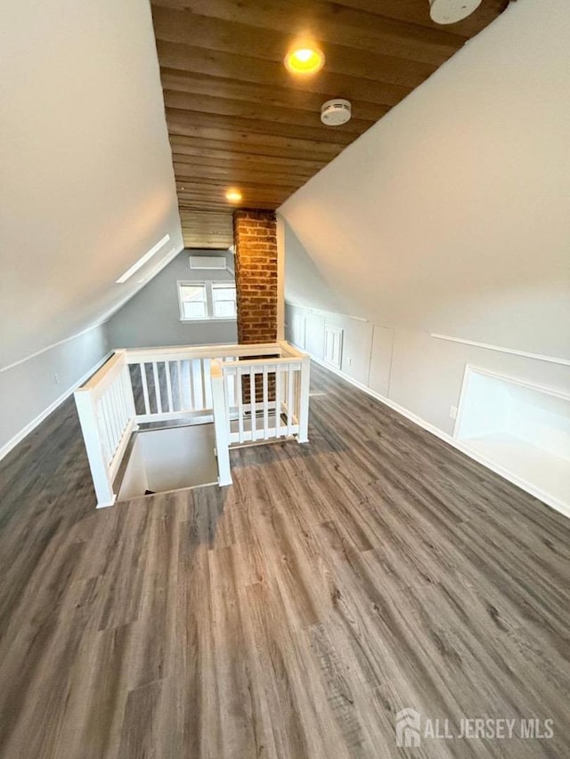 bonus room featuring dark hardwood / wood-style floors, vaulted ceiling, and wood ceiling