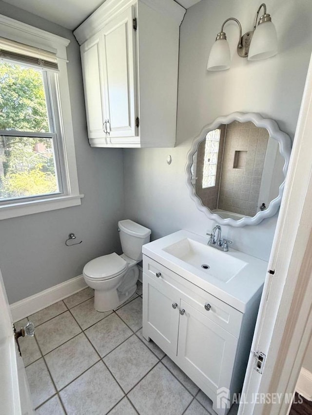 bathroom featuring tile patterned flooring, vanity, and toilet