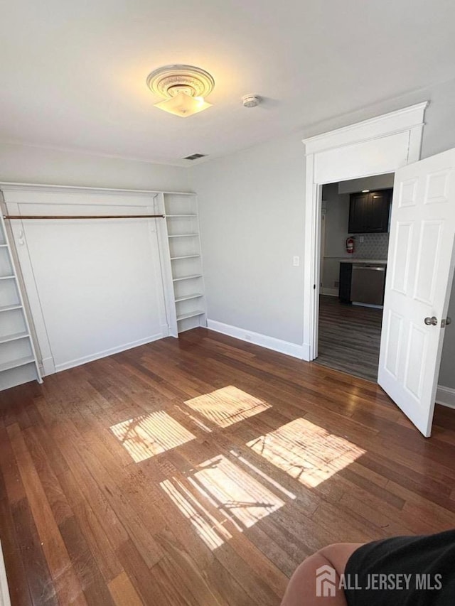 unfurnished bedroom featuring dark wood-type flooring