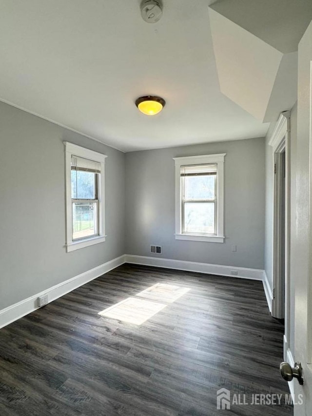 empty room with dark wood-type flooring