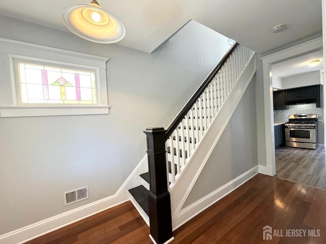 stairs with hardwood / wood-style floors