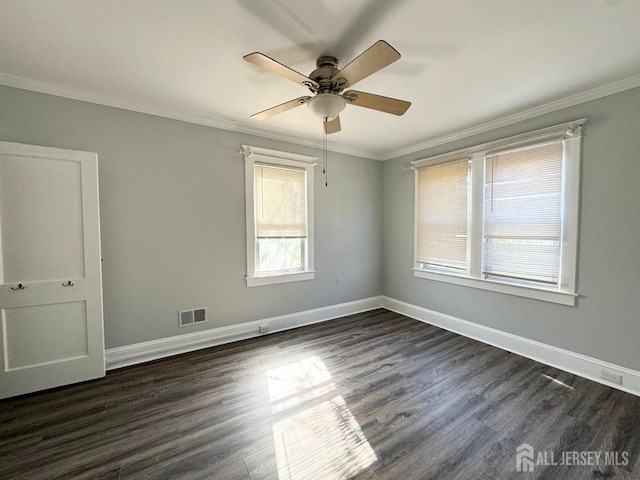 spare room with crown molding, ceiling fan, and dark wood-type flooring