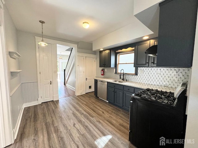 kitchen featuring sink, hardwood / wood-style flooring, dishwasher, black gas range, and hanging light fixtures