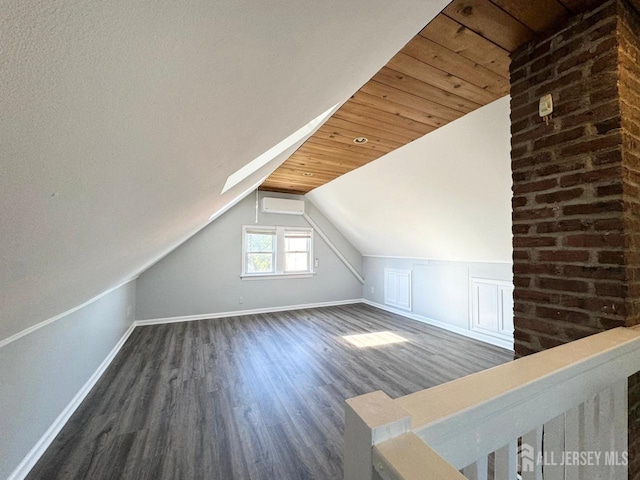 bonus room featuring dark hardwood / wood-style flooring, vaulted ceiling with skylight, wooden ceiling, and a wall mounted air conditioner