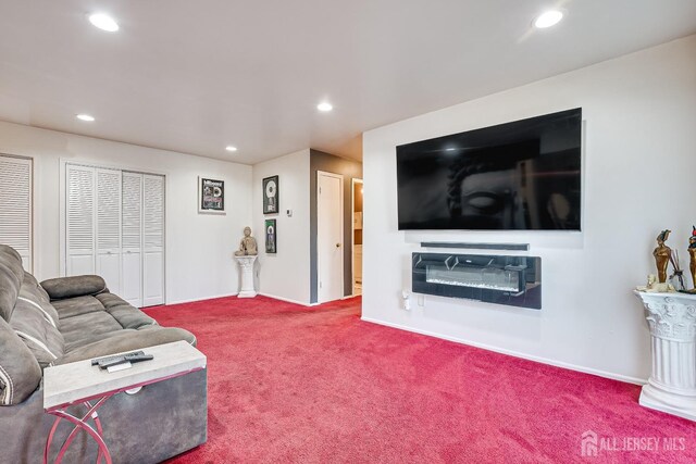 living room with a fireplace and carpet flooring