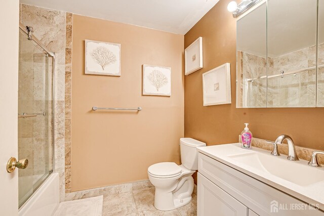 full bathroom featuring toilet, vanity, and shower / bath combination with glass door