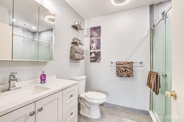 bathroom with a shower with door, vanity, and toilet