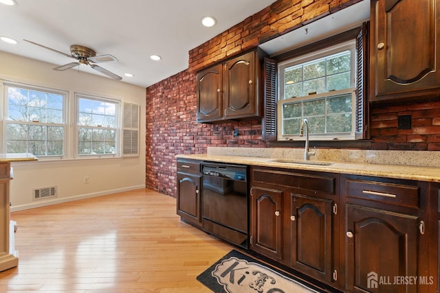 kitchen with brick wall, dark brown cabinets, visible vents, a sink, and dishwasher