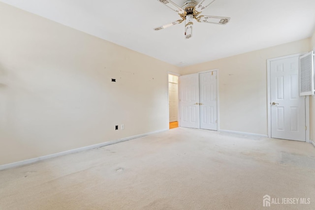 unfurnished bedroom featuring baseboards, a ceiling fan, and light carpet