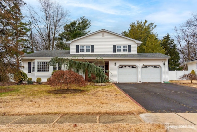 traditional-style house featuring driveway and an attached garage