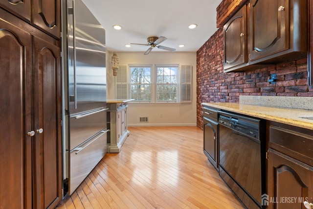 kitchen with dark brown cabinets, visible vents, black dishwasher, high end refrigerator, and light wood-type flooring