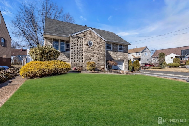 view of front of property with stone siding, a front yard, and a shingled roof