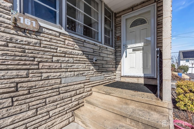 doorway to property with stone siding