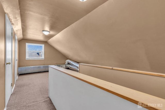 interior space with carpet floors and vaulted ceiling