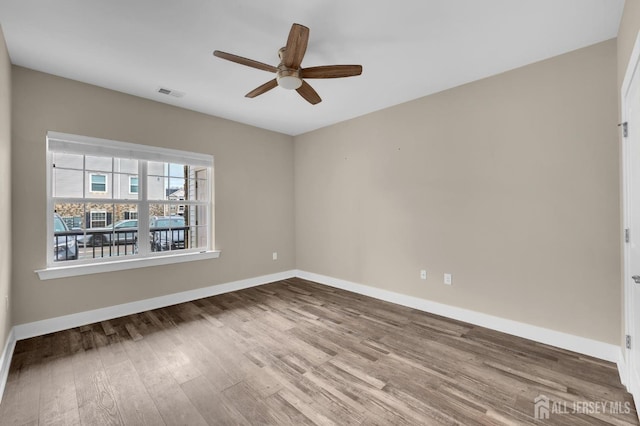 empty room featuring ceiling fan and hardwood / wood-style floors