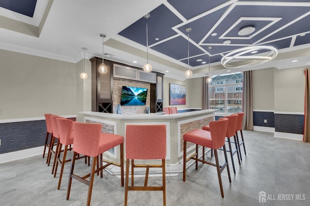 bar with crown molding and decorative light fixtures