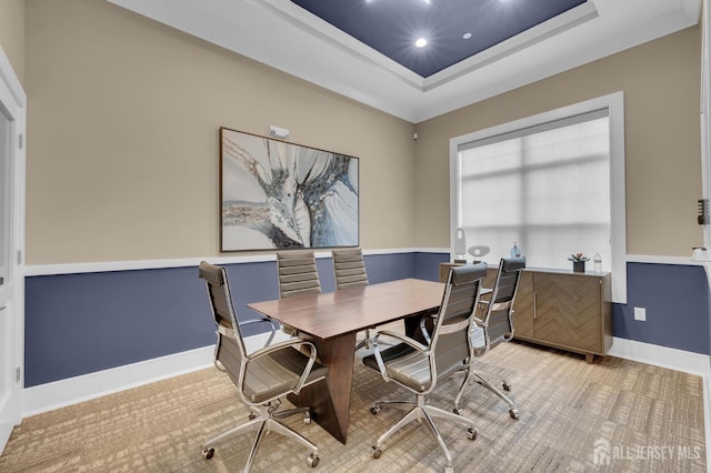 carpeted dining area featuring a tray ceiling